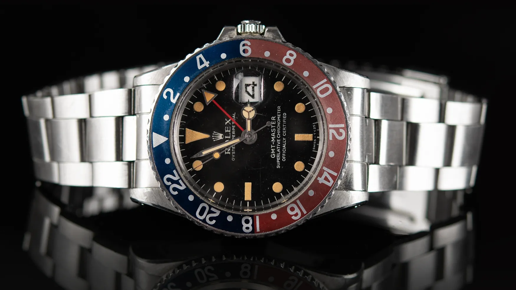 Vintage replica Rolex GMT Master Pepsi with Oyster bracelet, black dial, and red and blue bezel