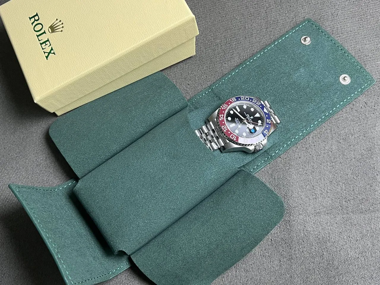 GMT Master II Pepsi placed inside premium green watch travel pouch