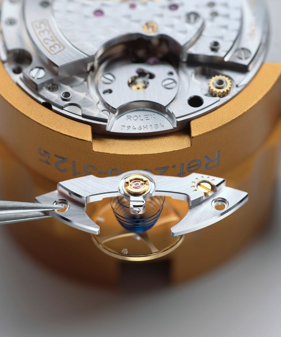 Rolex watch being serviced by a certified watchmaker at a service center
